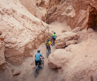 Friends riding bikes in Atacama