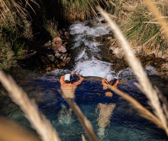 Couple enjoying puritama, Atacama.