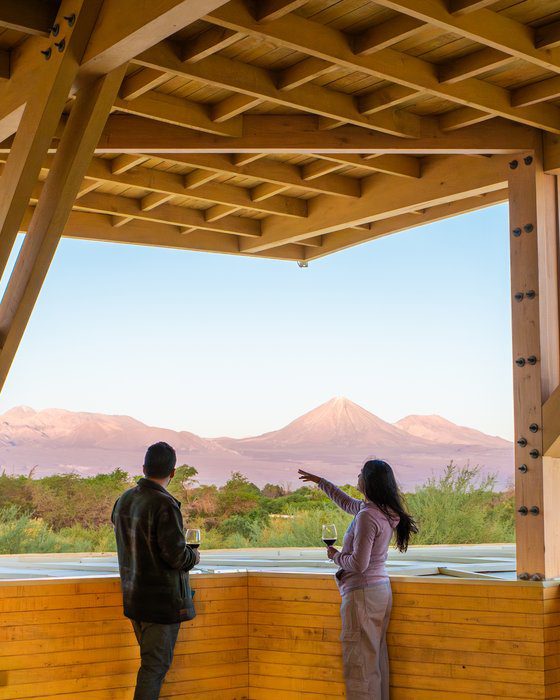 Couple looking out over the Atacama Desert landscape from Explora Lodge, Chile