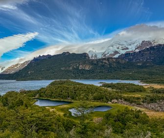 Aerial view of glacial lakes, native Patagonian forest, and snow-capped mountains along the Brazo Sur zone near El Calafate, Argentina