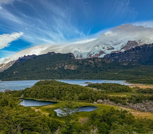 Aerial view of glacial lakes, native Patagonian forest, and snow-capped mountains along the Brazo Sur zone near El Calafate, Argentina