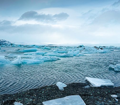 Floating icebergs and glacial ice on Jökulsárlón Glacier Lagoon, Iceland, under a dramatic Winter sky